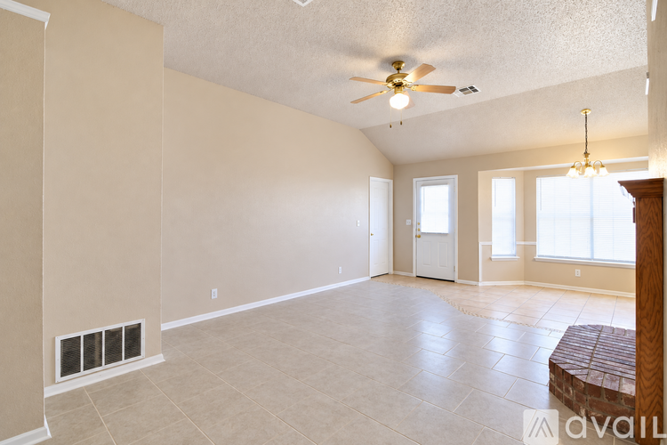 A spacious room with a ceiling fan and a window.