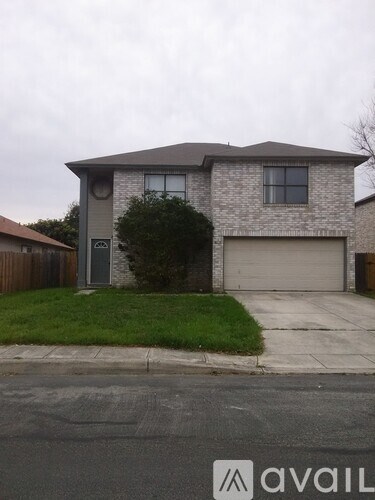 A house with a garage and a driveway in front.
