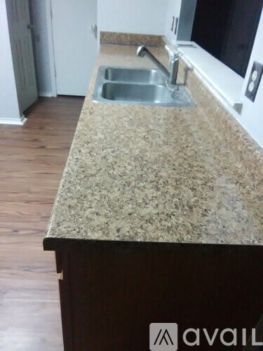 A kitchen counter with a sink and a window.