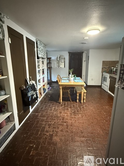 A kitchen with a table and chairs in the middle of the room.