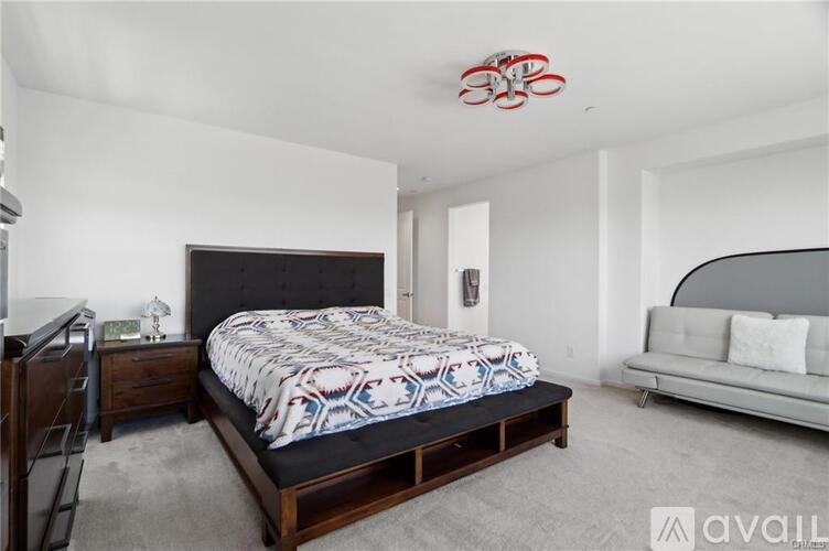 A bedroom with a large bed and a couch.