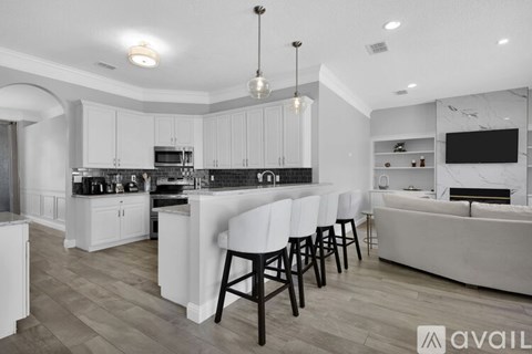 A modern kitchen with white cabinets and a large island.