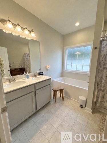 A bathroom with a white tub and sink.