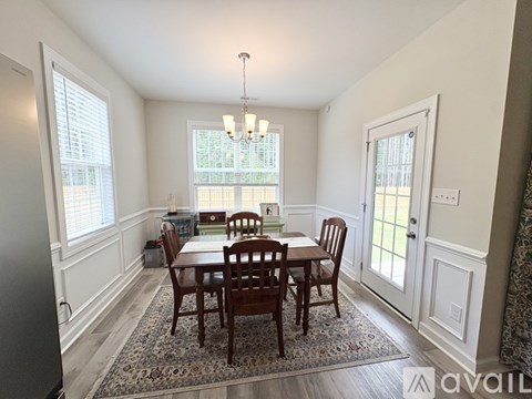 A dining room with a table set for four.