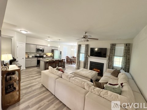A living room with a white couch and a fireplace.