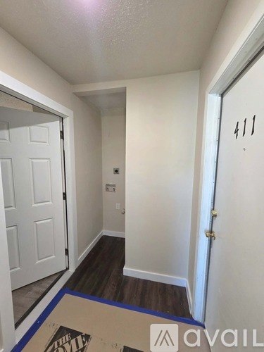 A hallway with a door on the right and a door on the left.