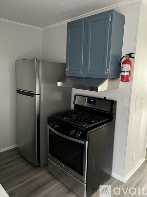 A kitchen with a stainless steel refrigerator and oven.