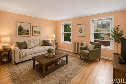 A living room with a white couch, a green armchair, a wooden coffee table, and pictures on the wall.