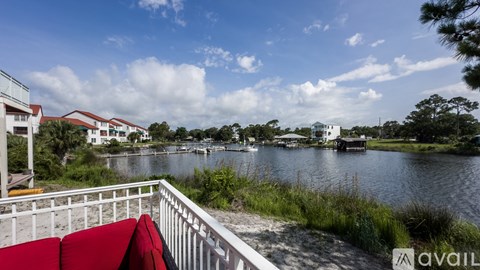 A view from a balcony overlooking a body of water with boats and buildings in the distance.
