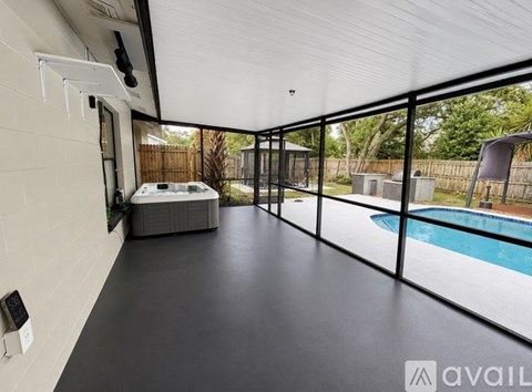 A modern house with a pool and a hot tub.