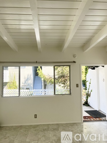 A room with a window and a door.