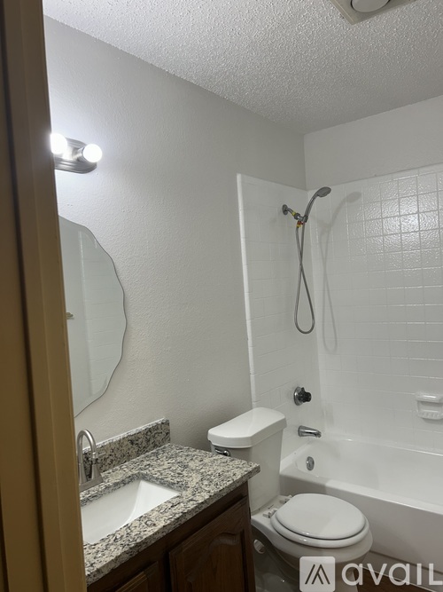 A bathroom with a sink, toilet, and bathtub.