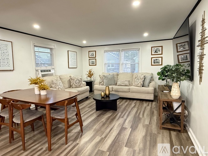 A living room with a couch, coffee table, and pictures on the wall.