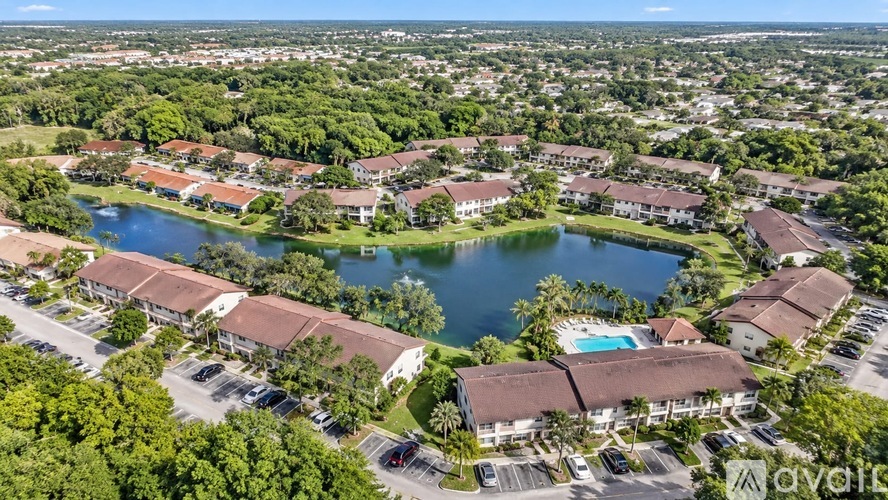 A bird's eye view of a resort with a swimming pool and a lake.