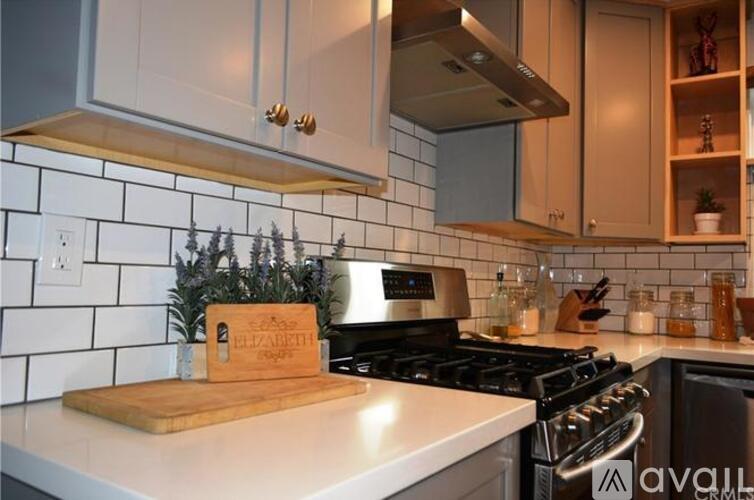 A kitchen with a cutting board that says Elizabeth on it.