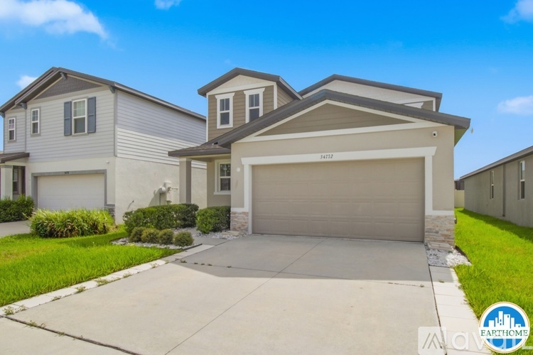 A modern two-story house with a garage is for sale.