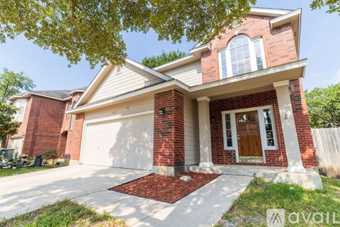 A house with a red brick exterior and a white garage door.