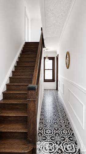 A staircase with a black and white tiled floor.