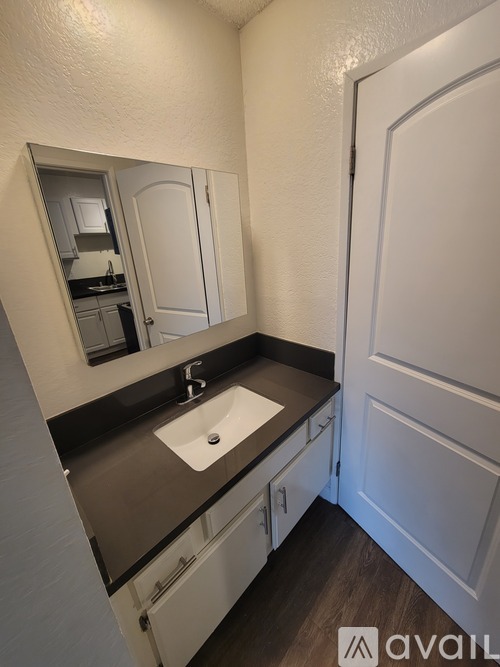A bathroom with a sink and mirror.