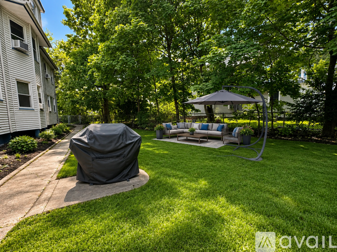 A backyard with a patio and a gazebo.