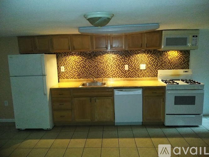 A kitchen with a white refrigerator, a white dishwasher, and a white stove.
