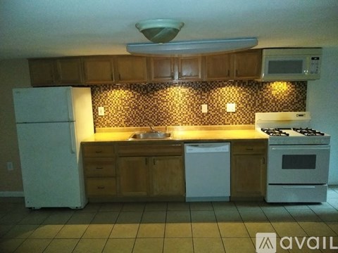 A kitchen with a white refrigerator, a white dishwasher, and a white stove.