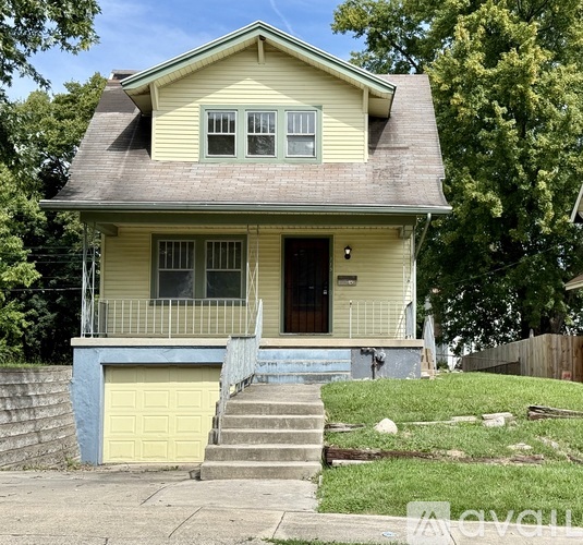 A yellow house with a blue garage door.