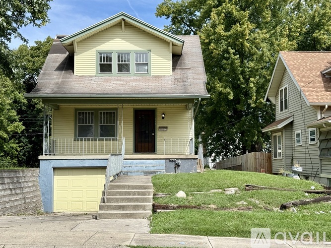 A yellow house with a blue garage door.