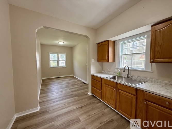 A kitchen with wooden cabinets and a sink.