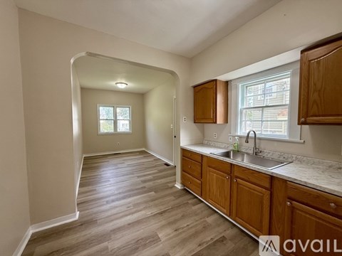 A kitchen with wooden cabinets and a sink.