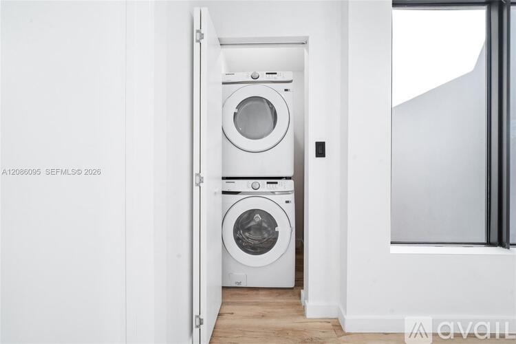 A white washing machine and dryer in a small laundry room.