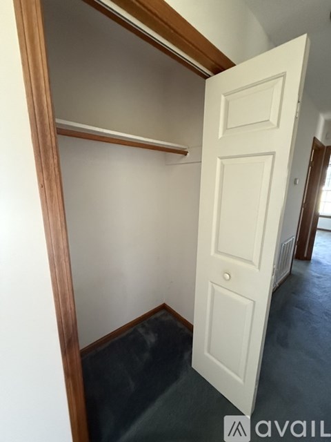 A white door is open to a hallway.