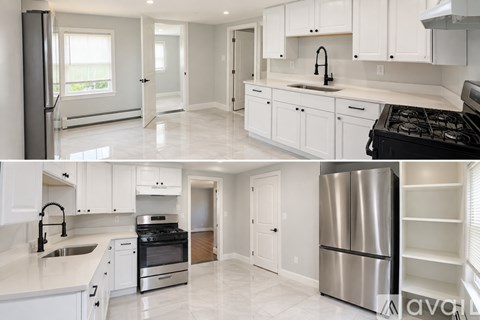 A modern kitchen with white cabinets and appliances.