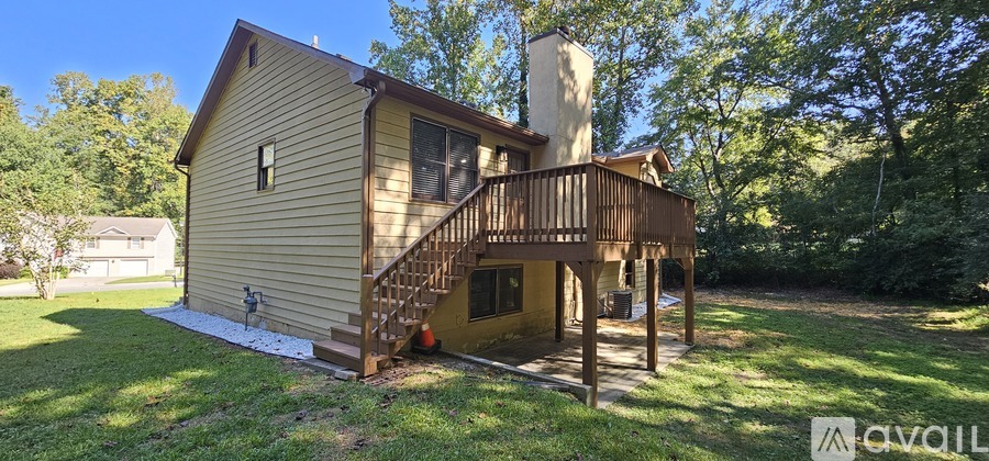 A house with a deck and a tower-like structure on the roof.