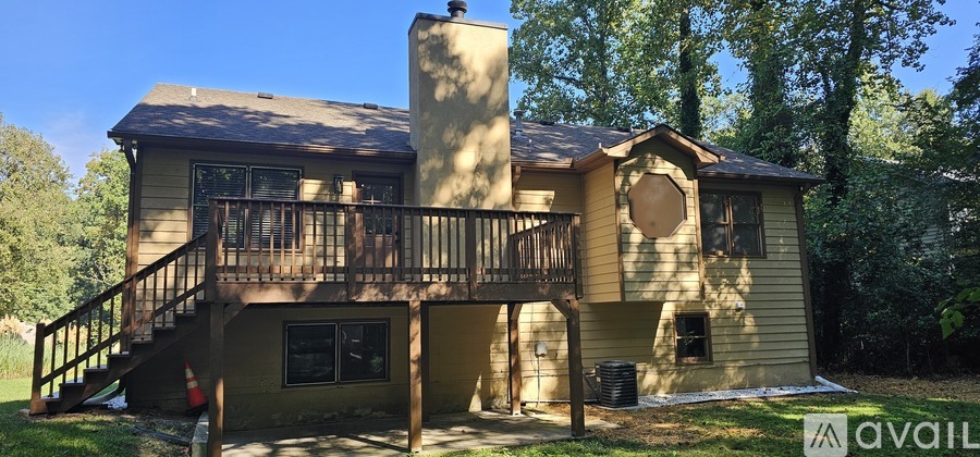A house with a balcony and a chimney is for sale.