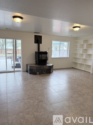 A living room with a fireplace and a television.