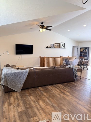 A bedroom with a large bed and a flat screen TV mounted on the wall.