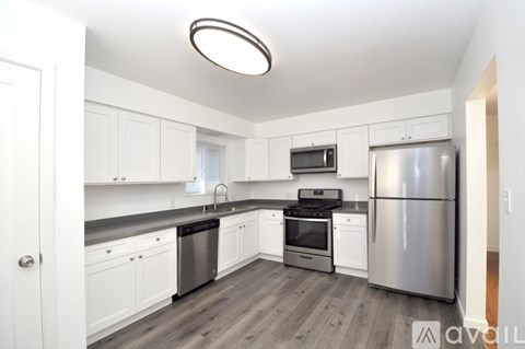 A kitchen with white cabinets and stainless steel appliances.