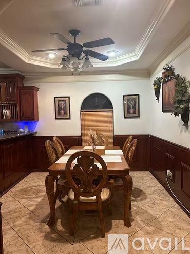 A dining room with a table set for six.