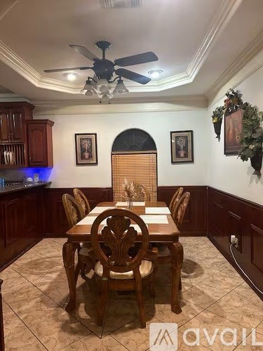 A dining room with a table set for six.