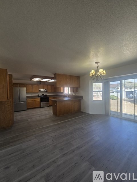 A spacious kitchen with wooden cabinets and a large island.