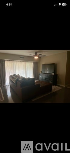 A living room with a couch and a television.