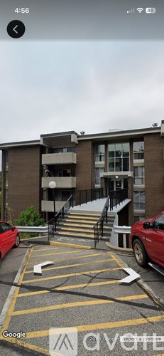 A parking lot with a building in the background.