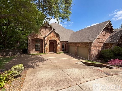 A house with a driveway and garage doors.
