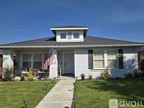 A house with a flag on the front porch.
