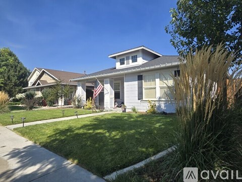 A house with a flag on the front porch is for sale.