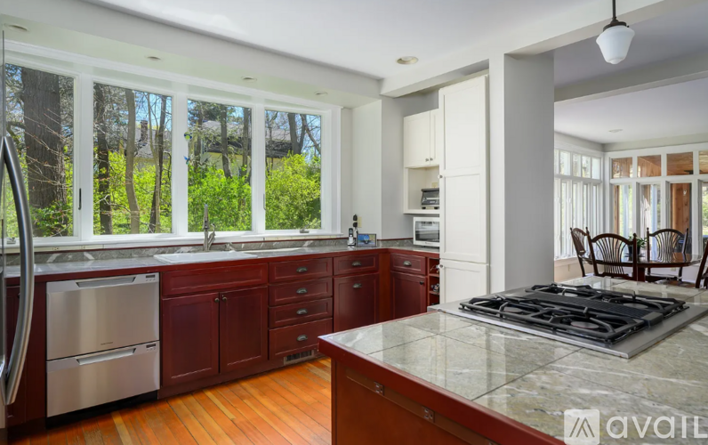 A kitchen with a stove top oven and a refrigerator.