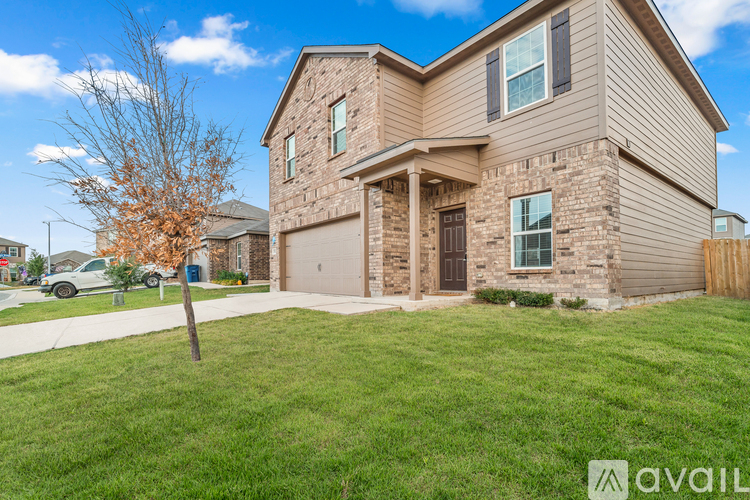A house with a brown and beige exterior is available for sale.