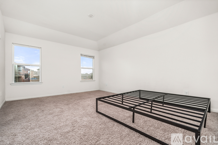 A bedroom with a large bed and carpeted floor.