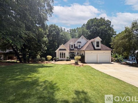 A house with a large front yard is for sale.